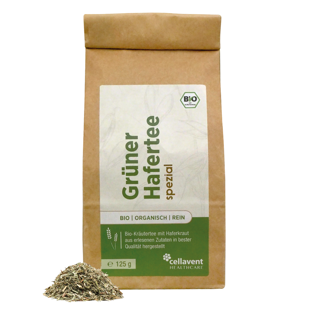 Grüner Hafertee Verpackung mit dem einer kleinen Menge des Inhaltsstoffes im Vordergrund